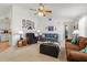 Cozy living room featuring a ceiling fan, comfortable seating, and neutral carpeting at 4846 Colonnades Club Blvd, Lakeland, FL 33811