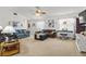 Spacious living room with neutral carpeting, a ceiling fan, and plenty of natural light through sheer curtains at 4846 Colonnades Club Blvd, Lakeland, FL 33811