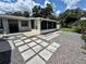 Charming backyard patio with pavers, gravel, landscaping, and access to the main house at 1618 Pineberry St, Lakeland, FL 33803