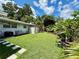 Large grassy backyard with shed and mature landscaping at 1618 Pineberry St, Lakeland, FL 33803