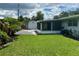 Manicured backyard featuring grass, paver stones, shed, and landscaping at 1618 Pineberry St, Lakeland, FL 33803