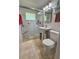 Clean and bright bathroom featuring a glass-enclosed shower and tiled floors and walls at 1618 Pineberry St, Lakeland, FL 33803