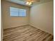 Empty bedroom with light-colored floors, ceiling fan, and natural light from a window at 1618 Pineberry St, Lakeland, FL 33803