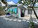 Home exterior and shed with paver stones and gravel in landscaped yard at 1618 Pineberry St, Lakeland, FL 33803
