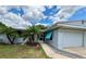 Charming single-story home with a well-manicured front yard and attached garage at 1618 Pineberry St, Lakeland, FL 33803