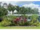 Well-manicured front yard with vibrant plants and lush palm trees at 1618 Pineberry St, Lakeland, FL 33803
