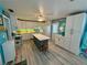Bright, beach-themed kitchen with white cabinets, a center island, and modern appliances at 1618 Pineberry St, Lakeland, FL 33803