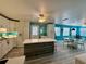 Open-concept kitchen and dining area with white cabinets, a kitchen island, and coastal decor at 1618 Pineberry St, Lakeland, FL 33803