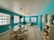 Bright living area with blue walls, a glass-top dining table, and modern decor at 1618 Pineberry St, Lakeland, FL 33803