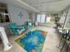 Relaxing sunroom with comfortable seating, colorful rug, and lots of natural light at 1618 Pineberry St, Lakeland, FL 33803