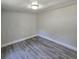 Bedroom with gray wood floors and white walls at 2434 Trenton E Rd, Lakeland, FL 33815