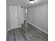 Bedroom featuring gray vinyl plank flooring with closet and doorway views at 2434 Trenton E Rd, Lakeland, FL 33815