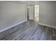 Bedroom with gray wood floors and white walls at 2434 Trenton E Rd, Lakeland, FL 33815