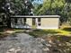 Tan home with a brown front door and well kept yard at 2434 Trenton E Rd, Lakeland, FL 33815