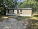 Exterior of single-story home featuring neutral siding, updated windows, and a front entrance with stairs at 2434 Trenton E Rd, Lakeland, FL 33815