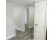 Hallway showcasing the newly installed gray vinyl plank flooring at 2434 Trenton E Rd, Lakeland, FL 33815