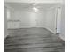 Living room with gray wood floor and white walls at 2434 Trenton E Rd, Lakeland, FL 33815