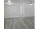 Spacious Living room with gray wood floors at 2434 Trenton E Rd, Lakeland, FL 33815