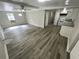 Open living area with modern flooring, ceiling fan, lots of natural light, and convenient kitchen access at 2434 Trenton E Rd, Lakeland, FL 33815