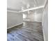 Gray wood floor living room with white walls and ceiling fan at 2434 Trenton E Rd, Lakeland, FL 33815