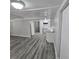 Gray wood floor living room with white walls at 2434 Trenton E Rd, Lakeland, FL 33815