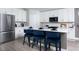Bright kitchen featuring white cabinets, an island with seating, and stainless steel appliances at 6236 Sw 95Th Pl, Ocala, FL 34476