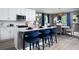 Modern kitchen with white cabinets, stainless steel appliances, and a stylish island with seating at 6236 Sw 95Th Pl, Ocala, FL 34476