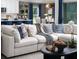 Bright living space with a comfortable sectional sofa, modern decor, and open access to the kitchen at 6236 Sw 95Th Pl, Ocala, FL 34476