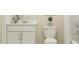 Well-lit bathroom featuring a toilet, vanity with storage, and a bathtub at 1133 Hour Glass Rd, Lakeland, FL 33801