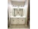 Modern bathroom featuring a double sink vanity with a white countertop, black hardware, and two backlit mirrors at 209 W 6Th St, Lakeland, FL 33805