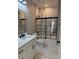 Bathroom featuring a shower/tub combo with marble tile, toilet, modern sink and a backlit mirror at 209 W 6Th St, Lakeland, FL 33805