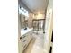 Bathroom featuring a shower/tub combo with marble tile, toilet, modern sink and a backlit mirror at 209 W 6Th St, Lakeland, FL 33805
