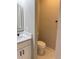 Half bathroom featuring a modern vanity with a white countertop, black hardware, and a backlit mirror at 209 W 6Th St, Lakeland, FL 33805
