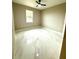 Neutrally painted bedroom featuring marble tile floors, a modern ceiling fan, and natural light from a window at 209 W 6Th St, Lakeland, FL 33805