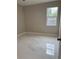 Cozy bedroom featuring modern flooring, neutral paint, a bright window, and a contemporary door at 209 W 6Th St, Lakeland, FL 33805
