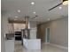 Bright kitchen featuring a quartz island, stainless steel appliances, and modern pendant lighting at 209 W 6Th St, Lakeland, FL 33805