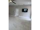 Open living room with sleek marble floors, modern ceiling fan, and a wall-mounted TV for entertainment at 209 W 6Th St, Lakeland, FL 33805