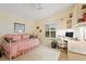 Bright bedroom/office space with desk, daybed, shelving, and a well-lit window at 2121 Escobar Ave, Lady Lake, FL 32159