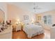 Serene bedroom with a ceiling fan, decorative bedside tables, and comfortable decor at 2121 Escobar Ave, Lady Lake, FL 32159