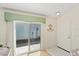 Bright entryway with tiled floors and a sliding glass door to the outside at 2121 Escobar Ave, Lady Lake, FL 32159