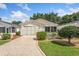 Charming single-story home with a well-manicured lawn and colorful landscaping at 2121 Escobar Ave, Lady Lake, FL 32159