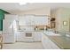 Well-lit kitchen featuring white appliances, ample counter space, and classic tile backsplash at 2121 Escobar Ave, Lady Lake, FL 32159