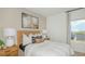 Comfortable bedroom featuring a woven headboard, neutral color palette, and calming artwork at 2415 Slippery Rock St, Auburndale, FL 33823