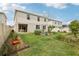 Landscaped backyard features garden beds, lush lawn, and partial fence at 392 Summer Squall Rd, Davenport, FL 33837