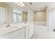 Bright bathroom featuring a double vanity, tub, and walk-in shower at 392 Summer Squall Rd, Davenport, FL 33837