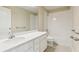 Bright bathroom features large mirror, quartz countertop, and tub with shower at 392 Summer Squall Rd, Davenport, FL 33837