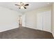 Neutral bedroom features plush carpeting, lighted ceiling fan, and large closet at 392 Summer Squall Rd, Davenport, FL 33837
