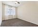 Bedroom featuring a fan, carpet floors, and a view of the neighborhood at 392 Summer Squall Rd, Davenport, FL 33837