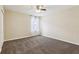 Neutral bedroom features plush carpeting, lighted ceiling fan, and sheer curtains at 392 Summer Squall Rd, Davenport, FL 33837