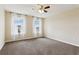 Bright bedroom with natural light, ceiling fan, and neutral carpet at 392 Summer Squall Rd, Davenport, FL 33837